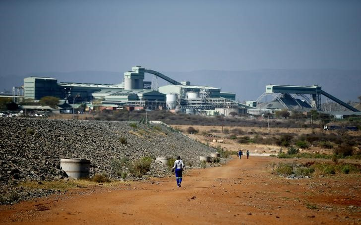 Locals walk towards the Mogalakwena platinum mine in Mokopane