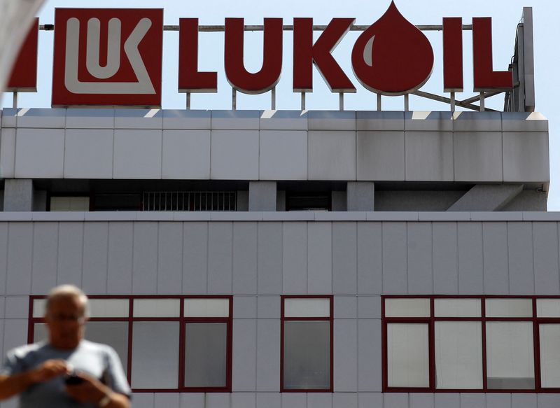 FILE PHOTO: Man walks in front of LUKOIL's headquarters in Sofia