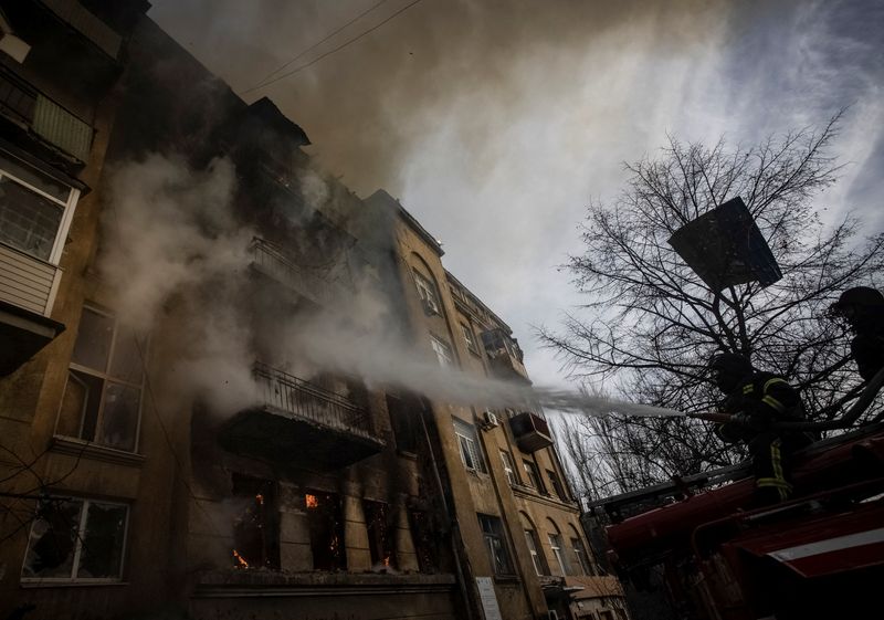 Firefighters work to put out a fire at a residential building hit by a Russian military strike in Bakhmut