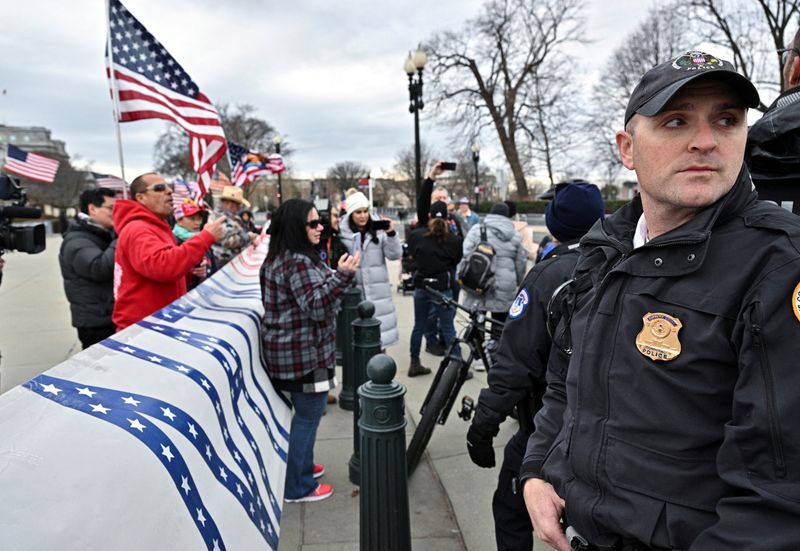 FILE PHOTO: Supporters of those arrested in the January 6, 2021 attack on the U.S. Capitol protest between the U.S. Supreme Court and the Capitol in Washington