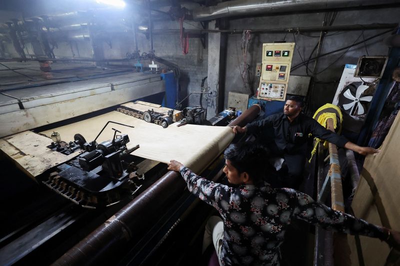 Labourers work at a dyeing unit in Panipat