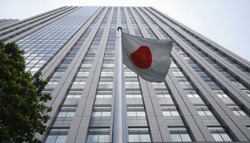 A Japanese national flag flies in front of the building of Japan's Financial Services Agency in Tokyo