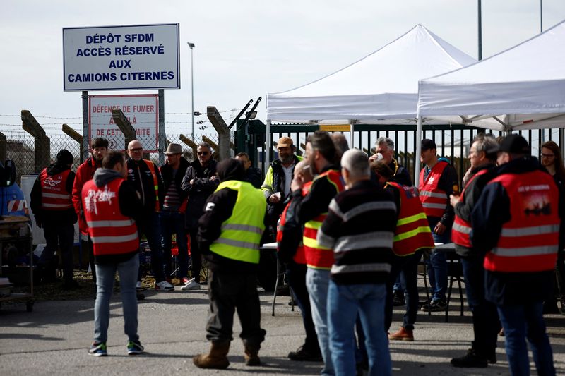 Workers on strike gather in front of the oil depot of the SFDM company in Donges
